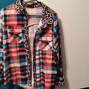 This is a brand new beautiful shirt. It is a XLarge but it runs small.